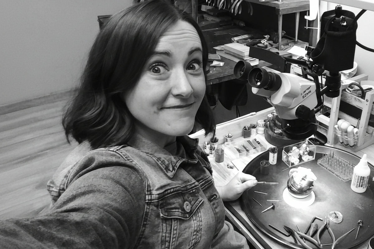 Person taking a selfie in a workshop with tools and equipment around